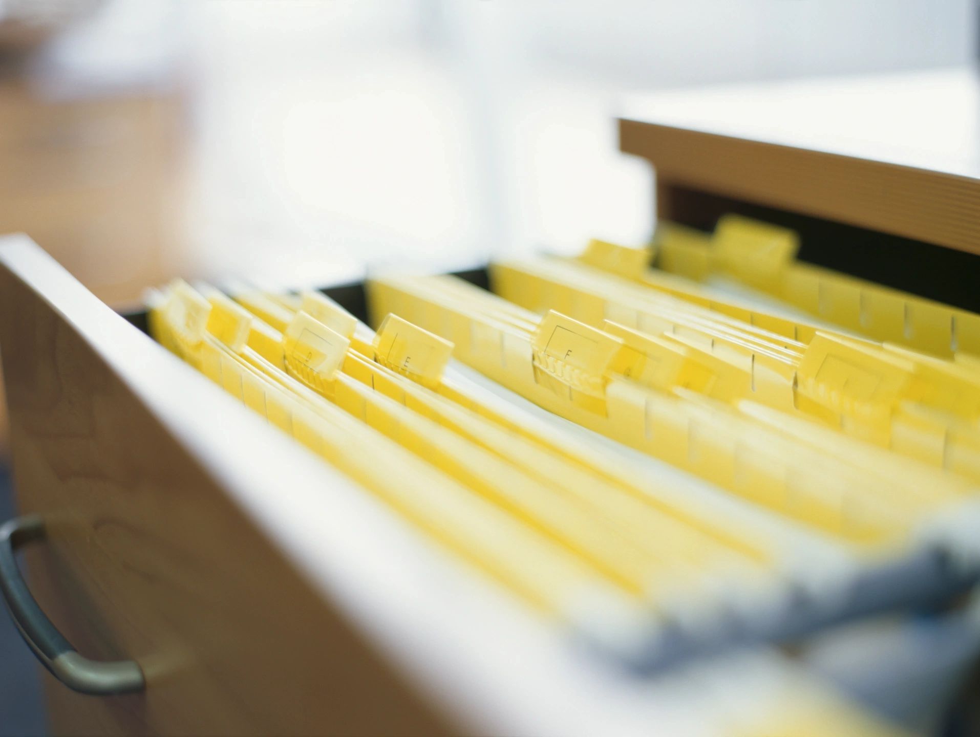 open filing cabinet showing file folders alphabetized
